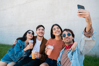 Portrait of smiling young woman using mobile phone