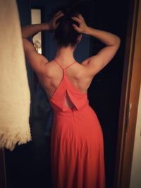 Rear view of woman standing at home