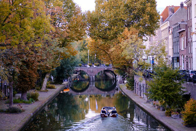 View along the tree-lined oudegracht  canal in utrecht city centre. autumn evening.