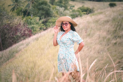 Young woman standing on field