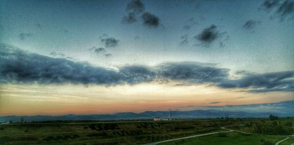 Scenic view of landscape against cloudy sky