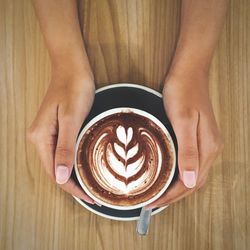 Close-up of hand holding coffee cup