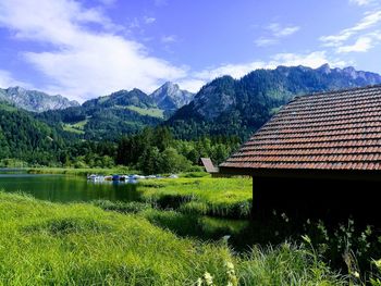 Houses by mountains against sky