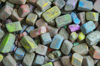 Colored pieces of chalk. broken pieces of colored dirty chalk