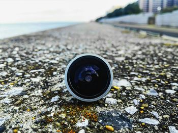 Close-up of camera on sea shore against sky