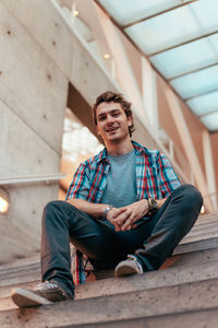 Portrait of young man sitting outdoors