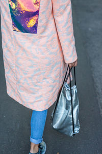 Low section of woman standing on street