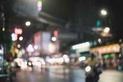 Defocused image of illuminated city street at night
