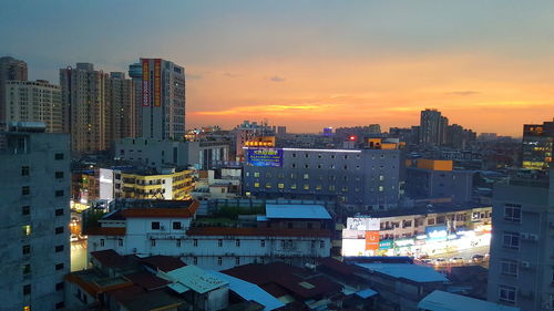 High angle view of buildings against sky during sunset
