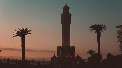 Silhouette of palm trees against sky during sunset