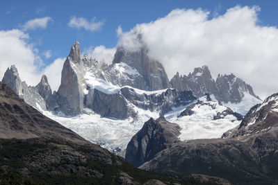 Scenic view of mountains against cloudy sky