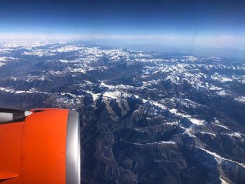 Aerial view of snowcapped mountains against sky