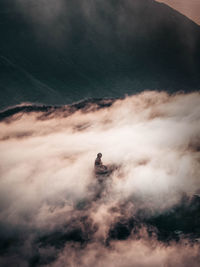 Man standing on mountain against sky