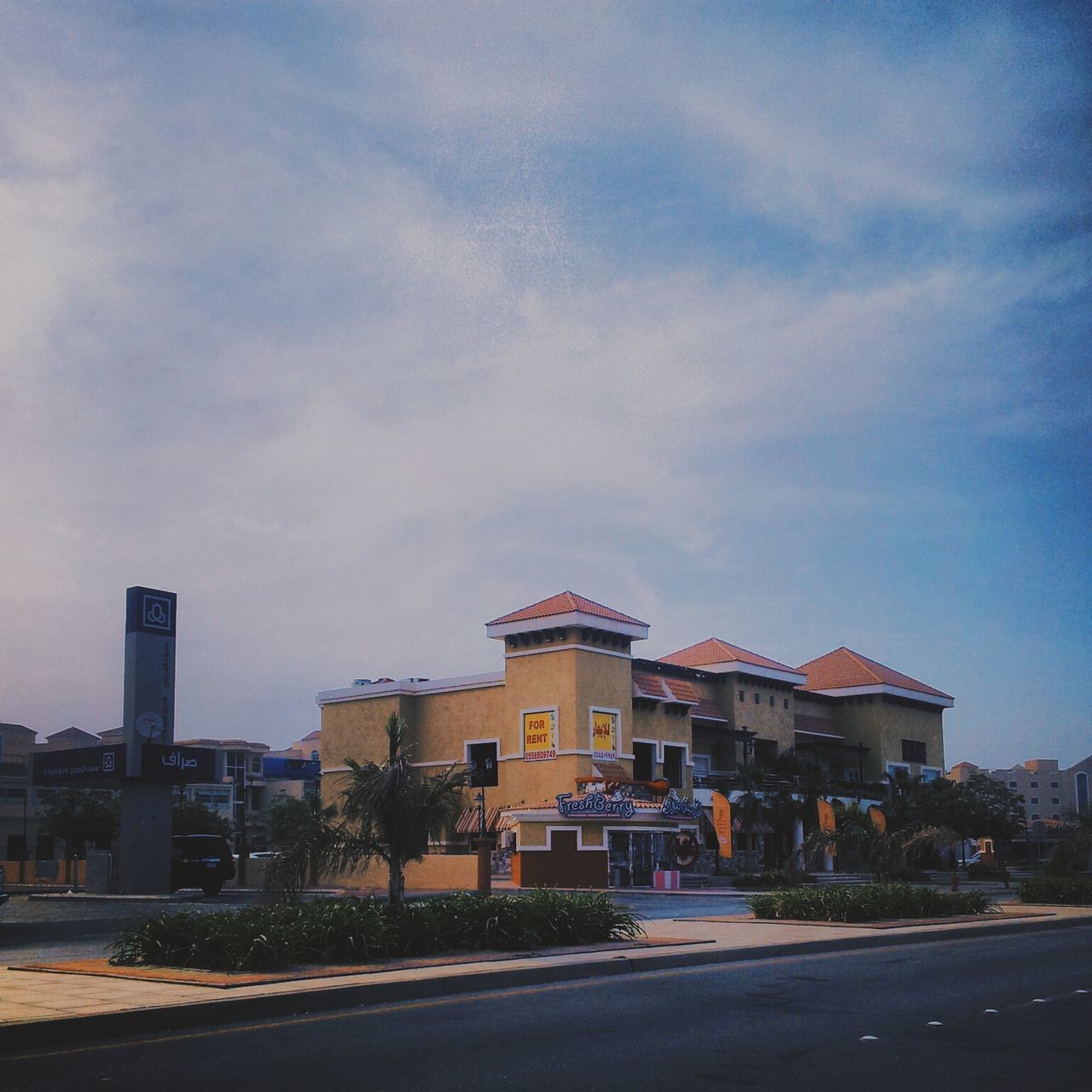 building exterior, architecture, built structure, sky, road, street, city, cloud - sky, residential structure, cloud, transportation, residential building, house, the way forward, road marking, blue, outdoors, building, cloudy, day