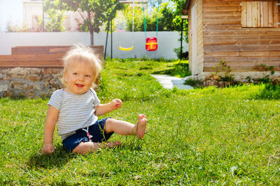 High angle view of boy sitting on grassy field