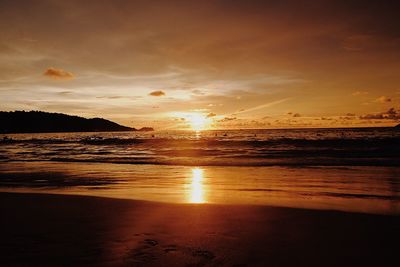 Scenic view of beach against sky during sunset