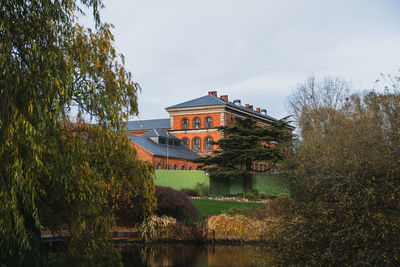 Building poking through plants in the botanical garden in copenhagen, demmark