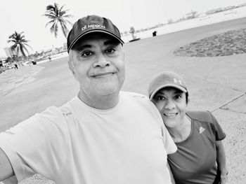 Portrait of smiling couple standing on promenade