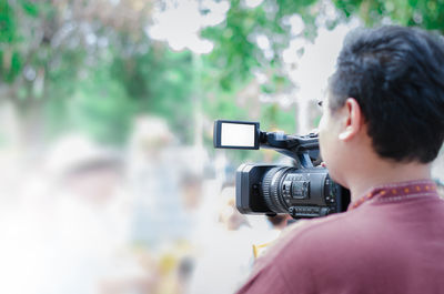 Rear view of man photographing