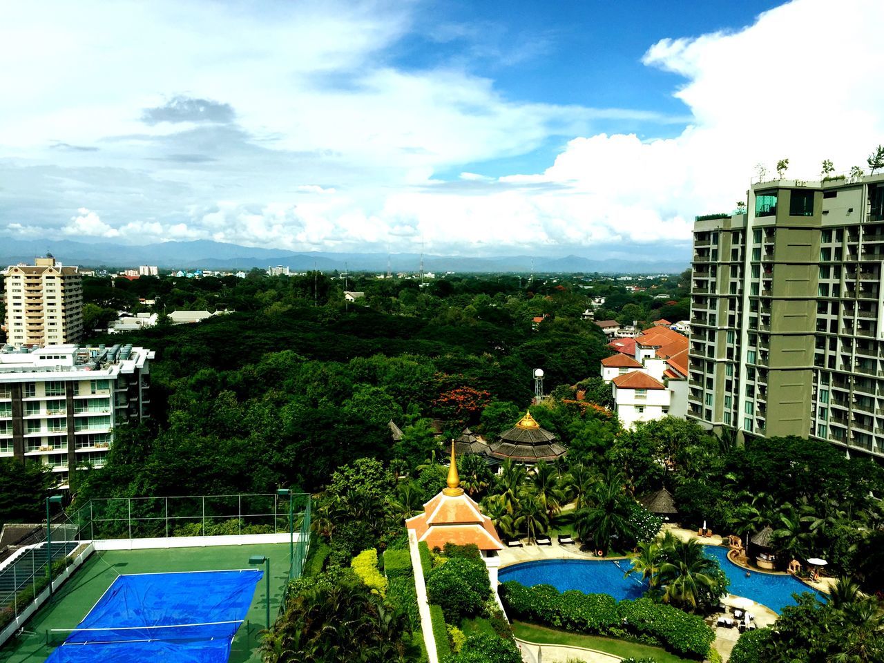 sky, building exterior, architecture, built structure, cloud - sky, tree, cloud, blue, water, green color, cloudy, sea, growth, nature, day, plant, outdoors, house, city, scenics