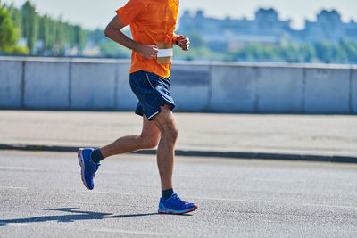 Full length of man running on road