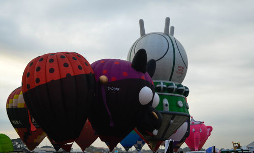 Low angle view of balloons against sky