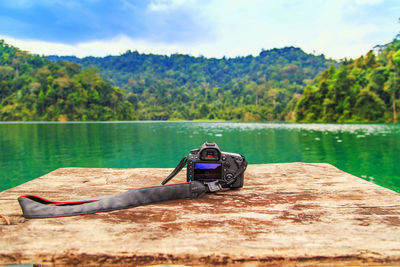 Man in boat on lake against mountain