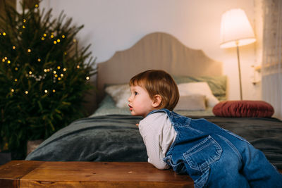 Little child at home for christmas with gifts