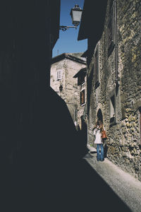 People walking by buildings in city