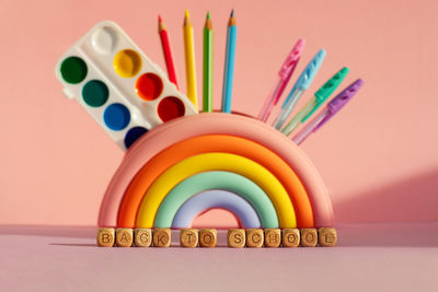 The concept of time to learn, diversity and inclusiveness. pencil case in the form of a rainbow