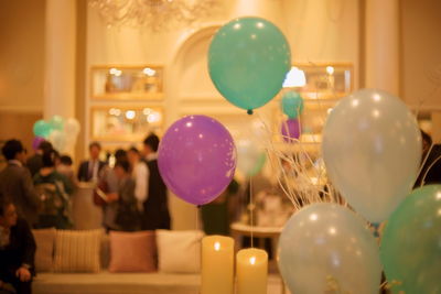 Close-up of balloons against illuminated lights