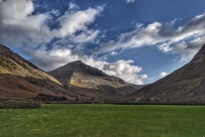 Scenic view of mountains against cloudy sky