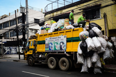 Vehicles on road against buildings in city