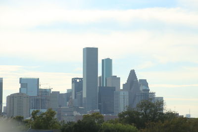 City skyline against cloudy sky