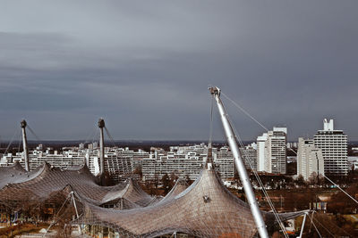 Buildings in city against cloudy sky