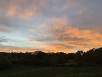 Scenic view of field against sky during sunset