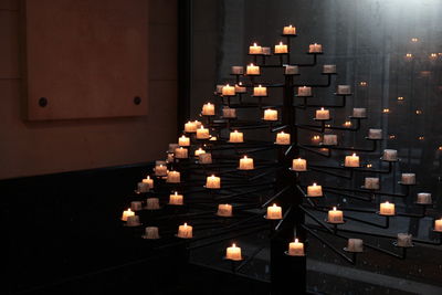 Illuminated candles in building