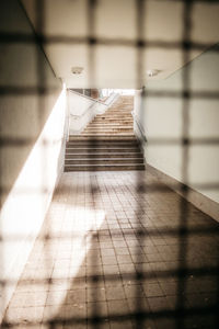 Shadow of railings on tiled floor