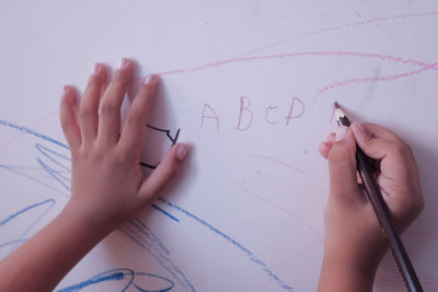 Child drawing on wall