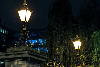 Low angle view of lamp post at night