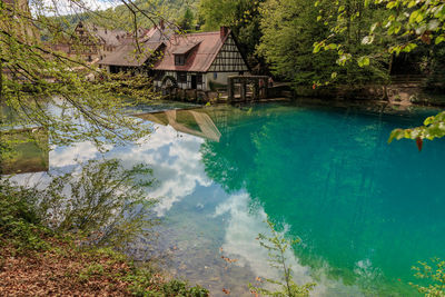 High angle view of swimming pool by lake against trees