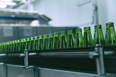 Close-up of glass bottles in factory