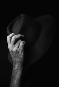 Close-up of man hand against black background