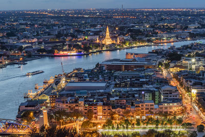 High angle view of illuminated city buildings at night