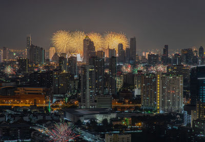 Illuminated cityscape against sky at night