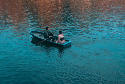 High angle view of people sailing boat in sea