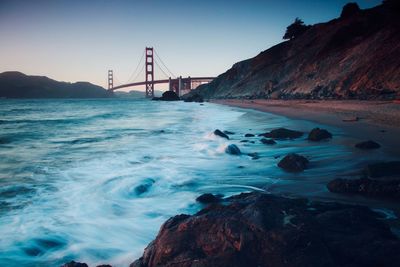 View of suspension bridge over sea