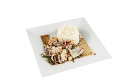 High angle view of cake on plate against white background