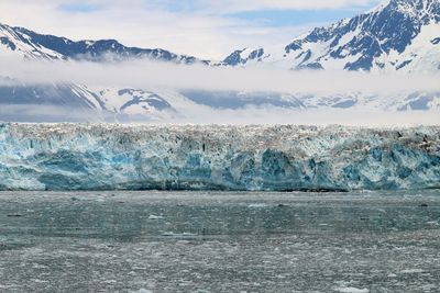 Scenic view of frozen sea against mountain range