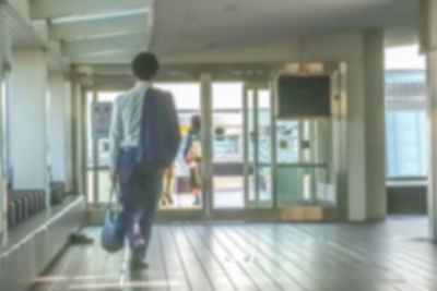 Rear view of man walking in corridor of building